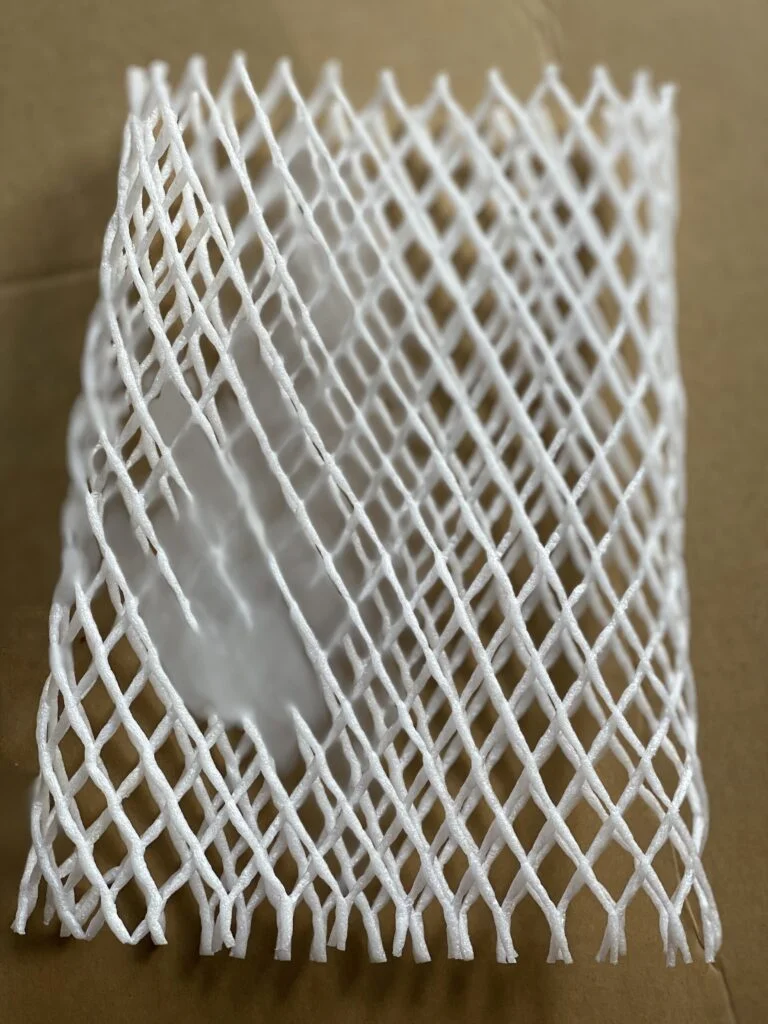 Separating white foam plastic packaging by hand into fine strands for the Kadam flower