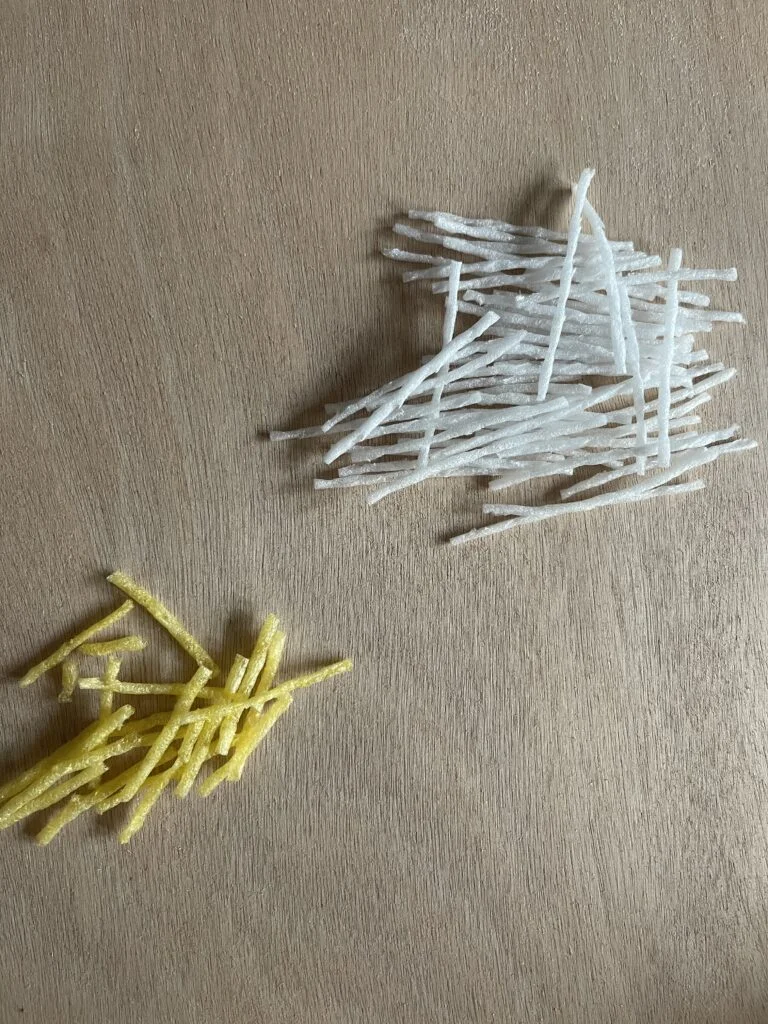 Tying foam strands together in the middle with yarn to create the spherical Kadam shape