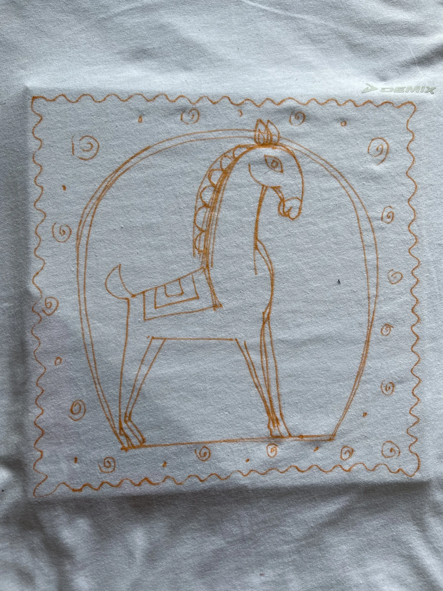 Drawing a folk art design directly onto the t-shirt with a pencil as a guide