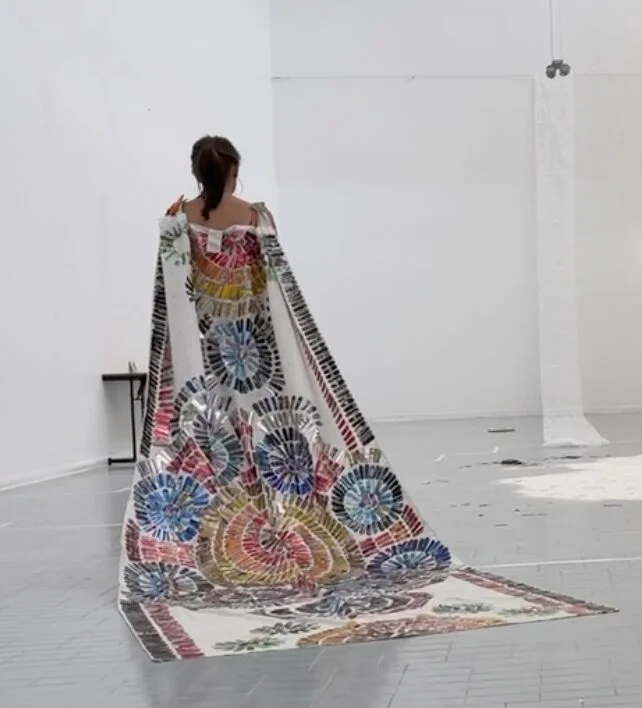 Textile sewn from cut beverage cans arranged in rows, stitched together to resemble fabric